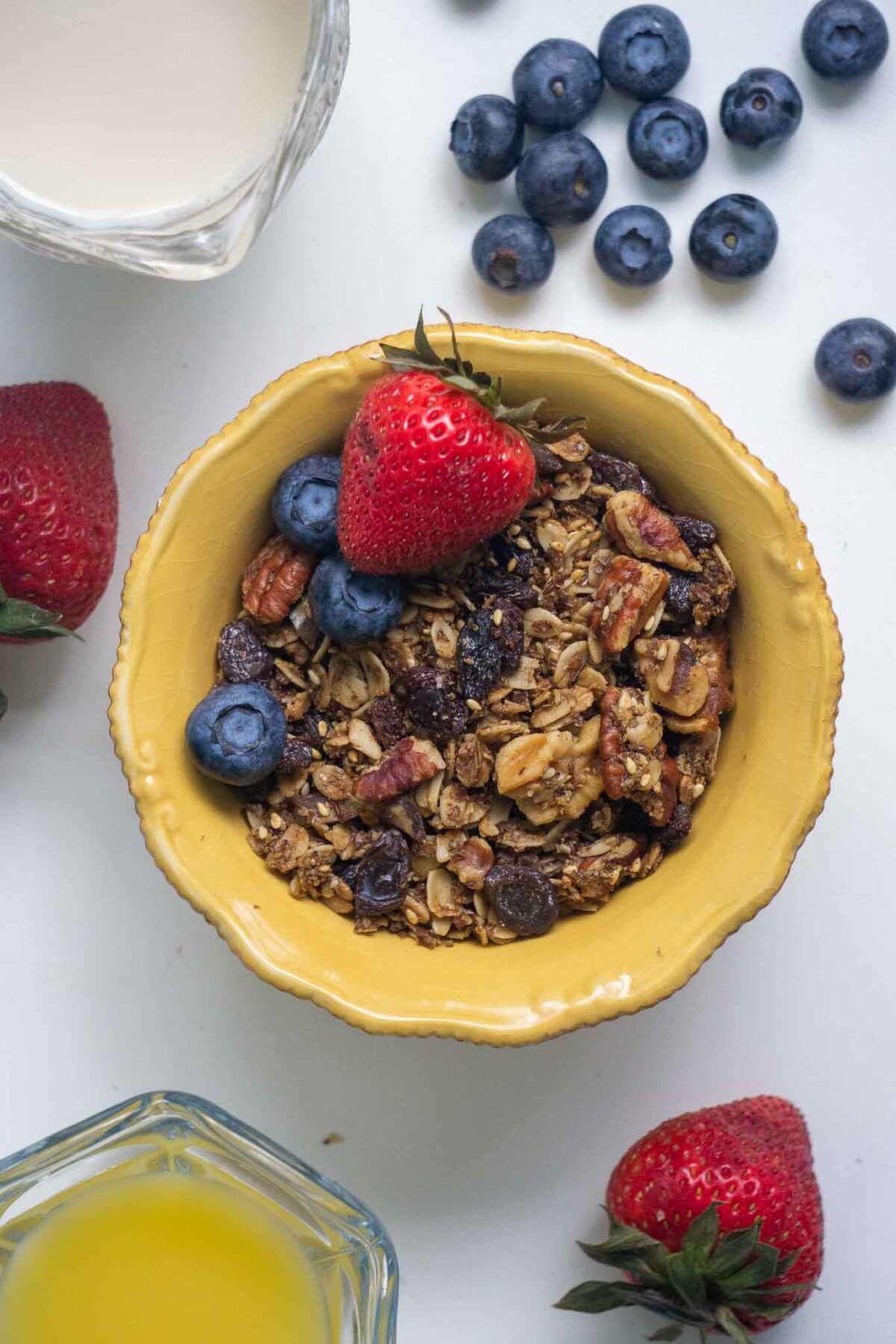 granola surrounded by berries