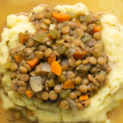 green lentils on mashed potatoes carrots and rosemary
