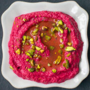 beetroot hummus close up with olive oil pistachio garnish