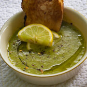 watercress soup garnished with lemon and crusty bread