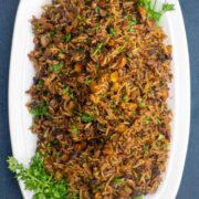 bed of dirty rice topped with parsley