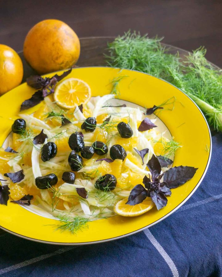 fennel orange and olive salad on yellow plate