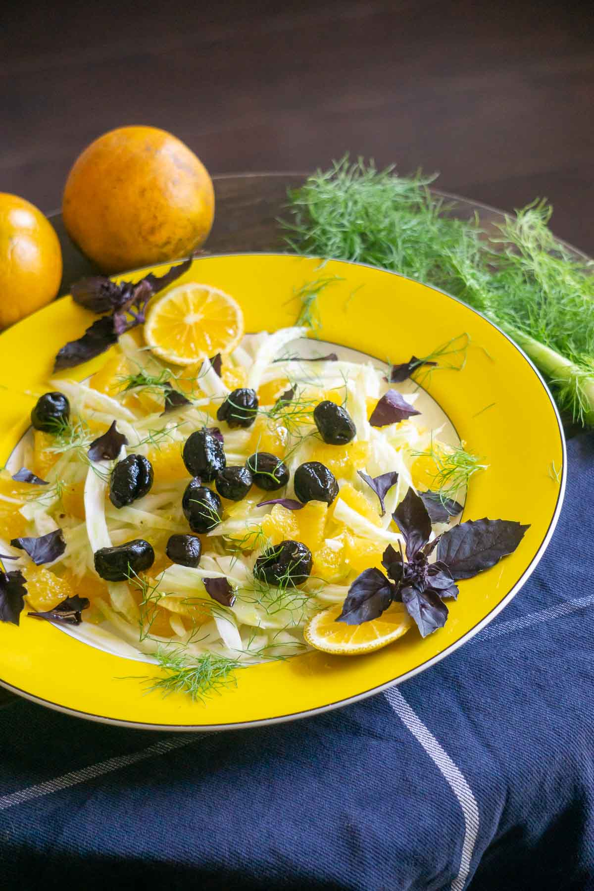 fennel orange and olive salad on yellow plate