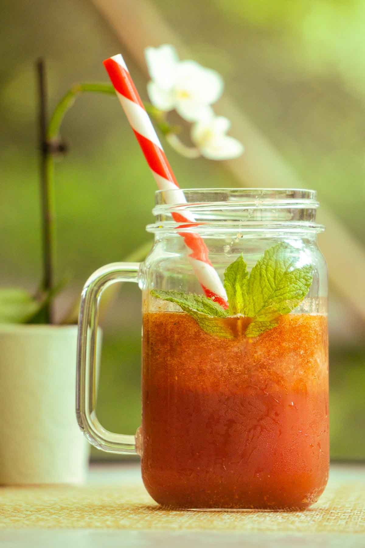 watermelon mint cooler with straw and orchid