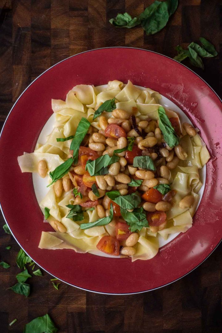 https://pithandrind.com/wp-content/uploads/2021/08/red-fresh-pasta-with-cannellini-beans-tomatoes-and-basil-720x1080.jpg