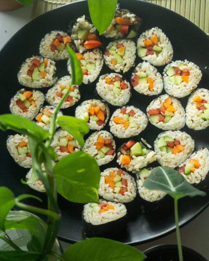 vegetarian sushi on a black plate