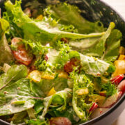 lettuce, tomatoes, onions, and peppers in creamy dressing